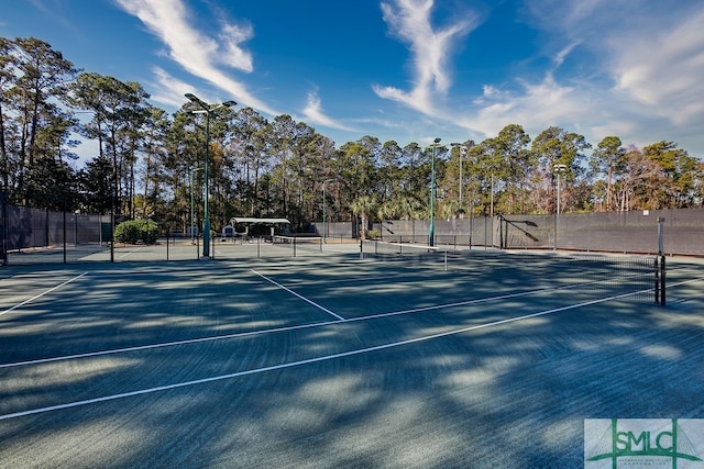 view of tennis court featuring fence