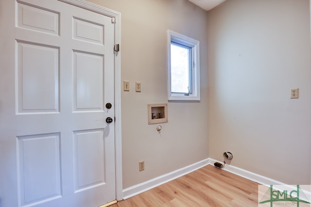 laundry area with laundry area, baseboards, washer hookup, and light wood finished floors