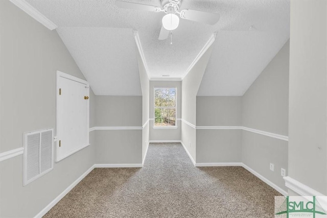 bonus room with carpet flooring, ceiling fan, a textured ceiling, and vaulted ceiling