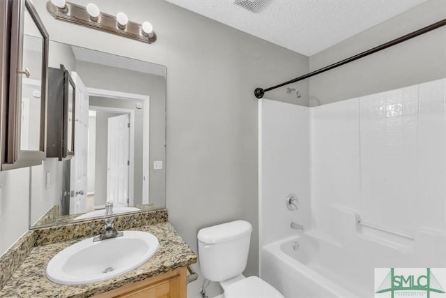 full bathroom with vanity, toilet, a textured ceiling, and bathtub / shower combination