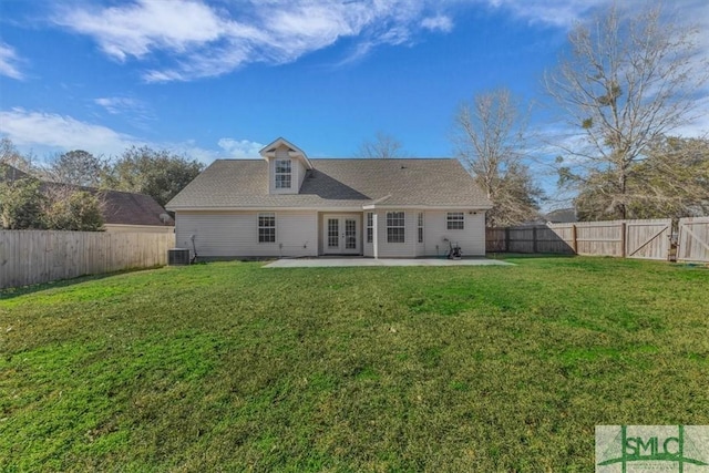 rear view of house with a yard, cooling unit, and a patio area