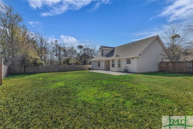 back of property with a yard and a patio