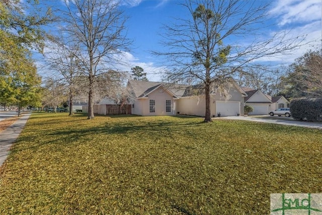 view of front of property with a garage and a front lawn