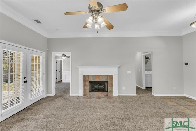 52 Sedgefield Ct, Richmond Hill, GA 31324 - unfurnished living room featuring ornamental molding, a ceiling fan, carpet, french doors, and a tiled fireplace