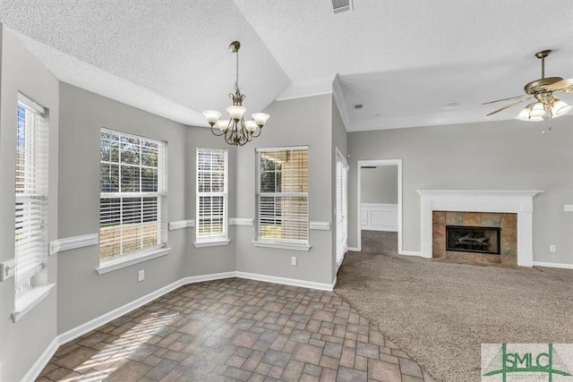 52 Sedgefield Ct, Richmond Hill, GA 31324 - unfurnished living room with a chandelier, ceiling fan, a textured ceiling, a tile fireplace, and brick patterned floors