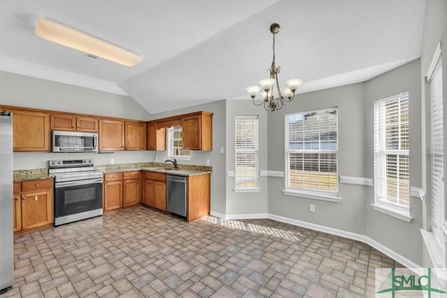 52 Sedgefield Ct, Richmond Hill, GA 31324 - kitchen featuring appliances with stainless steel finishes, a chandelier, vaulted ceiling, brown cabinetry, and brick patterned floors