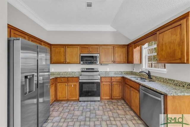 kitchen featuring crown molding, light stone counters, sink, and stainless steel appliances