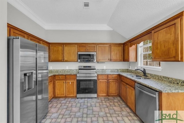 52 Sedgefield Ct, Richmond Hill, GA 31324 - kitchen featuring stainless steel appliances, brown cabinets, light stone counters, crown molding, and brick patterned floors
