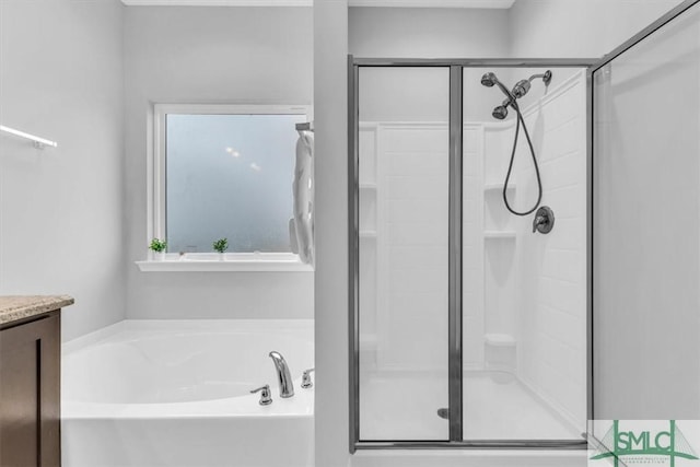 bathroom featuring vanity and separate shower and tub