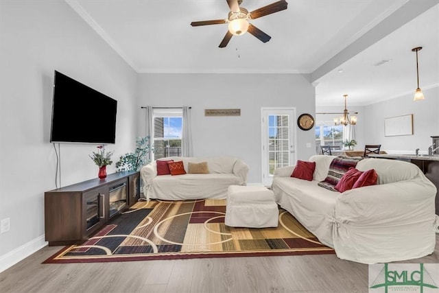 living room with crown molding, a healthy amount of sunlight, and wood-type flooring