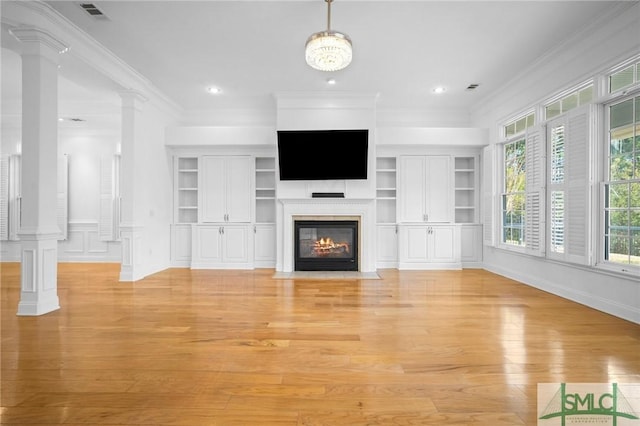 unfurnished living room featuring ornamental molding, light hardwood / wood-style floors, decorative columns, and built in shelves