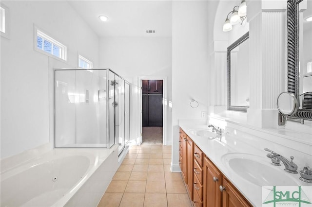 bathroom with plus walk in shower, tile patterned flooring, and vanity