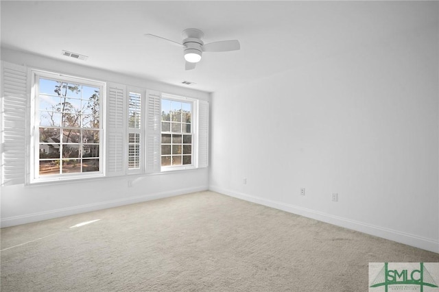 carpeted empty room with a healthy amount of sunlight and ceiling fan