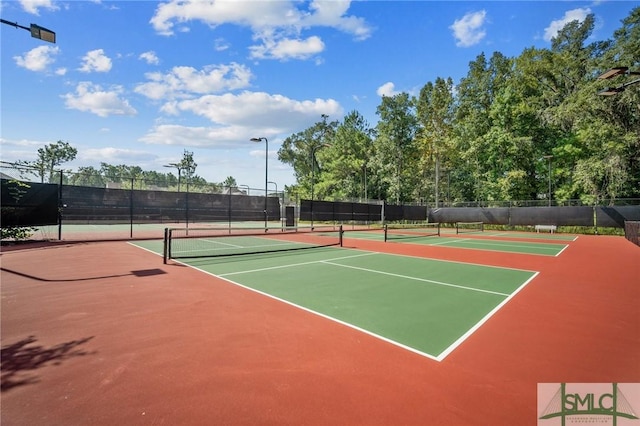 view of tennis court with basketball hoop