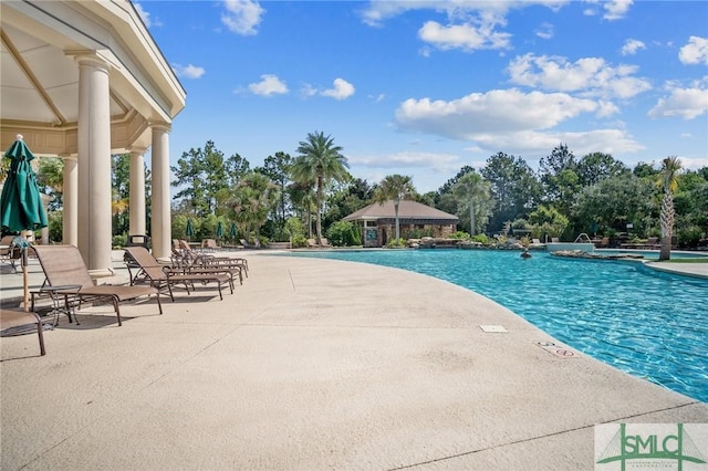 view of swimming pool with a patio and a gazebo