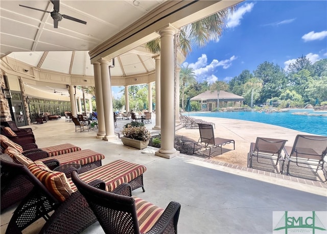 view of patio featuring a gazebo, ceiling fan, and a community pool