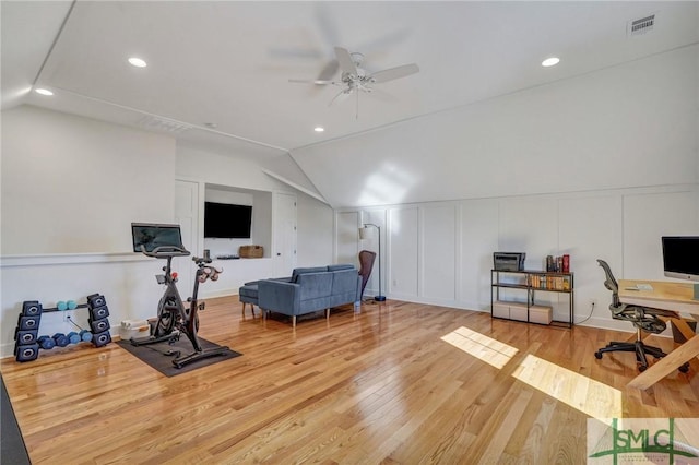 exercise area with lofted ceiling, wood-type flooring, and ceiling fan