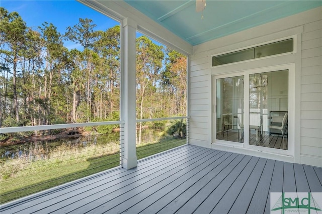 unfurnished sunroom with ceiling fan