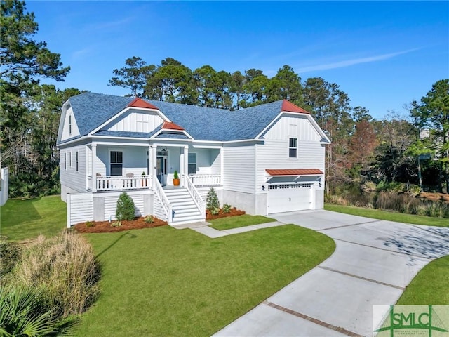 view of front of house featuring a garage, a front yard, and a porch