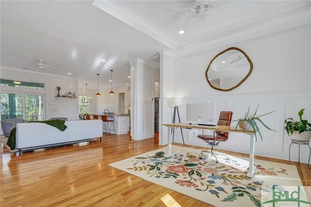 interior space featuring crown molding, a tray ceiling, ceiling fan, and light hardwood / wood-style floors