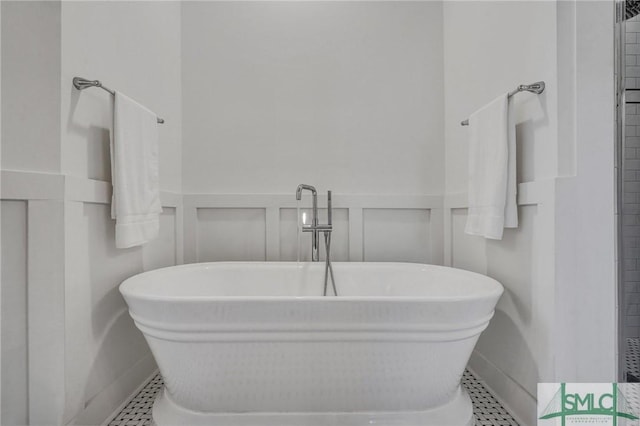 bathroom featuring tile patterned floors and a bathtub