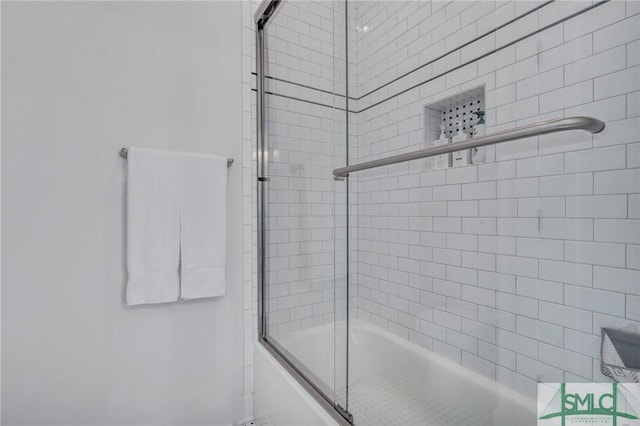 bathroom featuring shower / bath combination with glass door