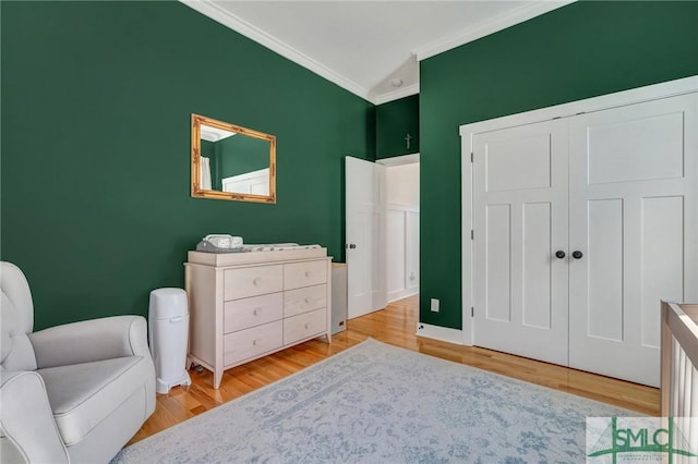 interior space featuring ornamental molding, a closet, and light wood-type flooring