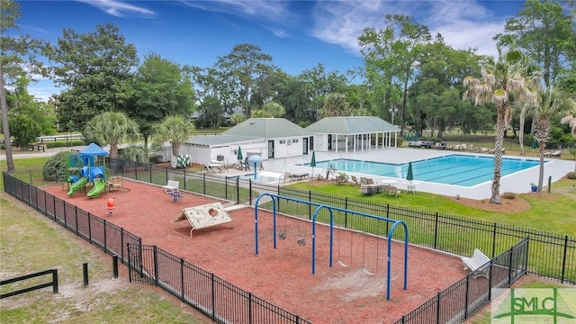 view of swimming pool featuring a playground