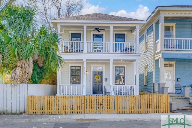 view of front of house featuring covered porch, ceiling fan, and a balcony