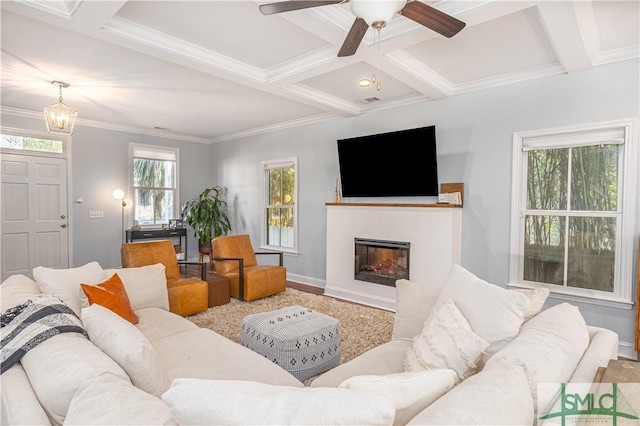 living room with ceiling fan, beamed ceiling, coffered ceiling, and ornamental molding