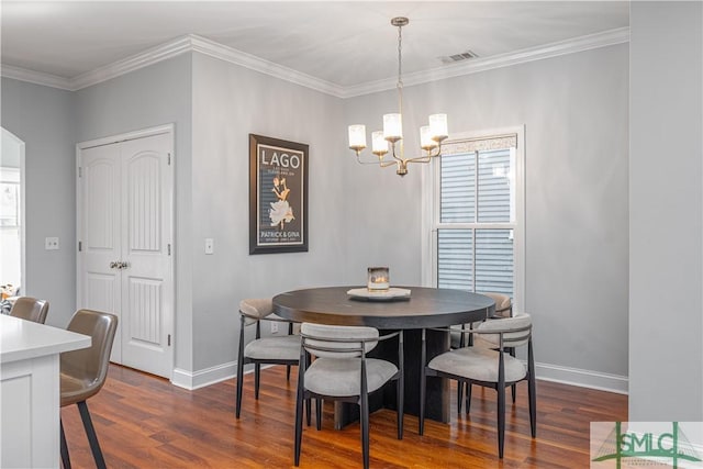 dining space with crown molding, dark hardwood / wood-style floors, and an inviting chandelier