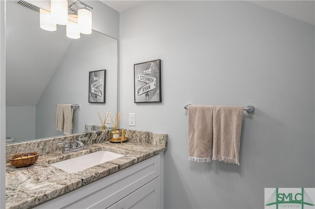 bathroom featuring vanity and vaulted ceiling