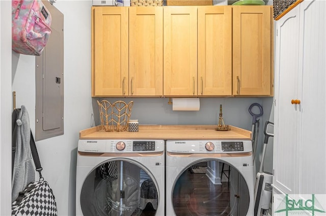 washroom featuring cabinets, electric panel, and washing machine and clothes dryer