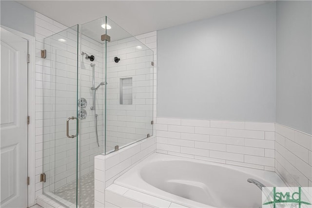 bathroom featuring separate shower and tub