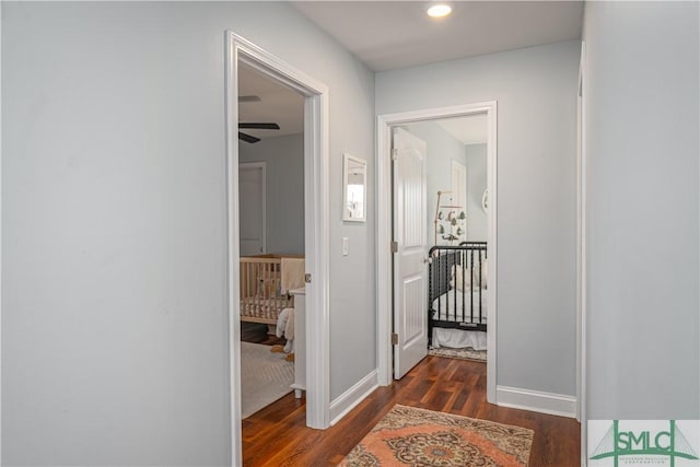 hallway with dark wood-type flooring