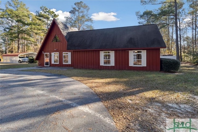 view of outbuilding featuring a yard and a carport