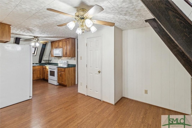 kitchen with hardwood / wood-style flooring, ceiling fan, and white appliances