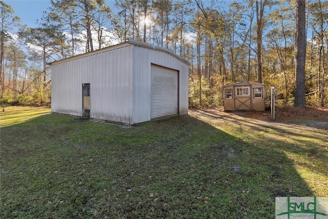 view of outbuilding with a garage and a lawn