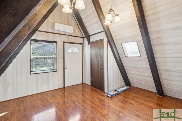 entryway with wood ceiling, wood-type flooring, lofted ceiling with beams, an AC wall unit, and a chandelier