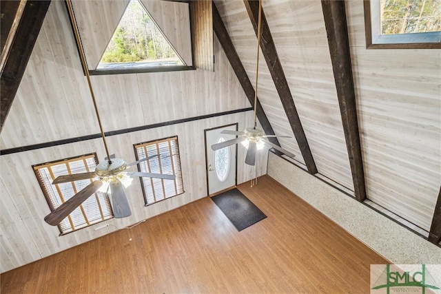 entrance foyer featuring ceiling fan, high vaulted ceiling, wood-type flooring, and beam ceiling