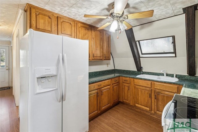 kitchen with range with electric cooktop, sink, white fridge with ice dispenser, ceiling fan, and light hardwood / wood-style floors