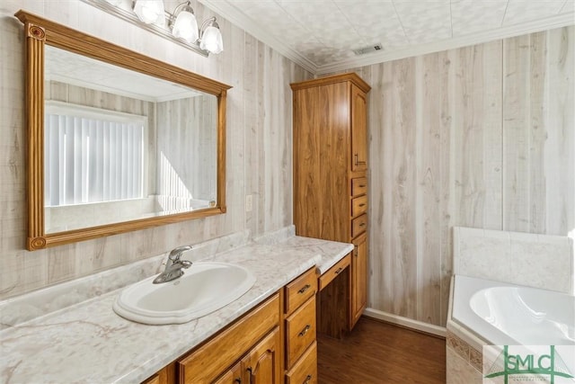 bathroom featuring vanity, hardwood / wood-style floors, crown molding, and tiled bath