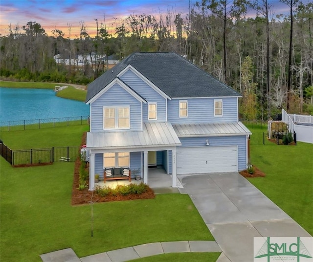 view of front of home with a yard and a garage