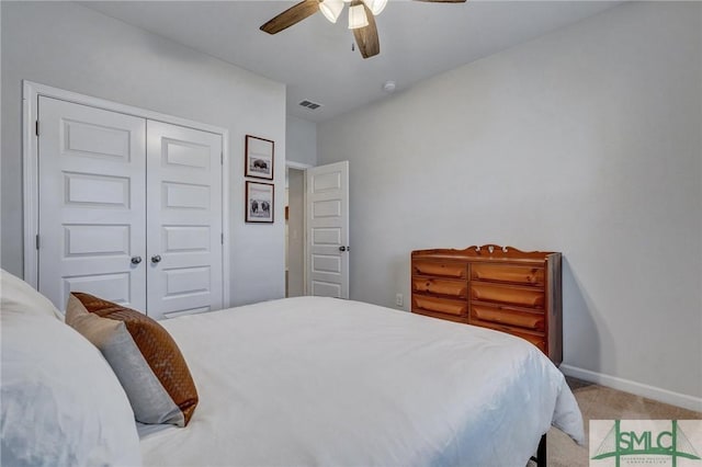 carpeted bedroom with ceiling fan and a closet