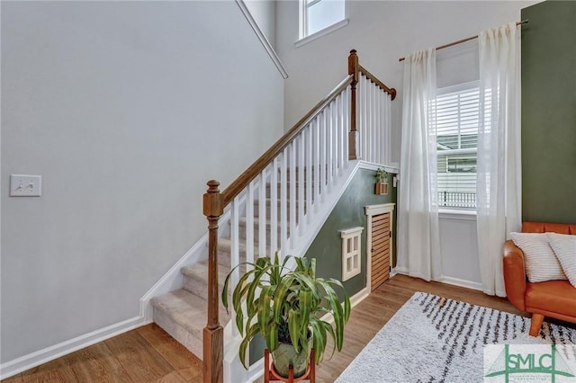 stairway featuring hardwood / wood-style floors and plenty of natural light