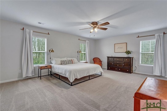 bedroom with ceiling fan and light colored carpet