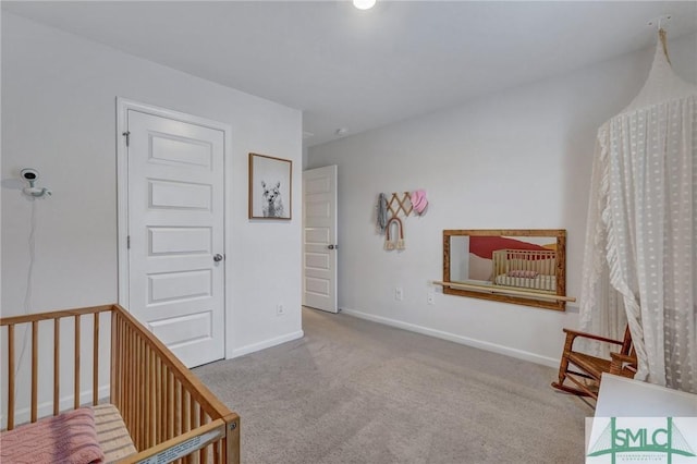 carpeted bedroom featuring a crib