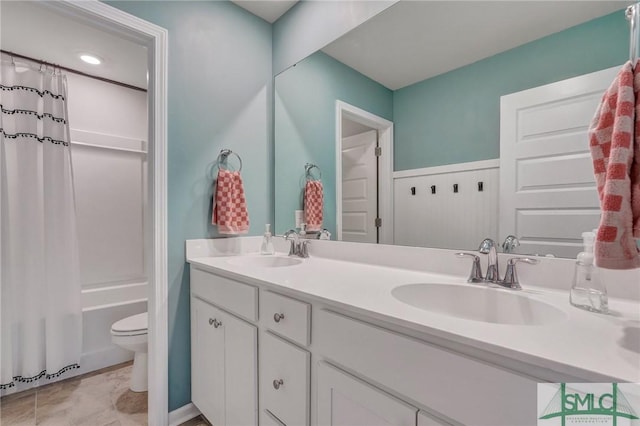 full bathroom featuring shower / bath combination with curtain, vanity, and toilet