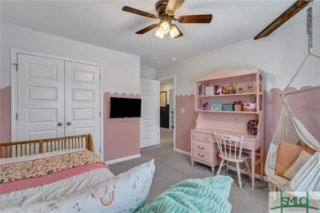 bedroom with ceiling fan, a closet, and light colored carpet