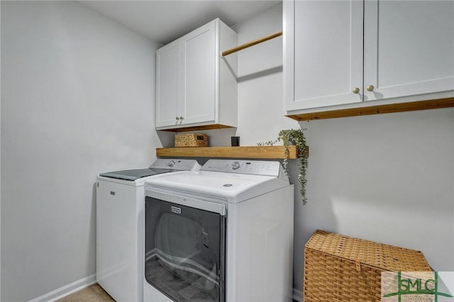 washroom featuring cabinets and independent washer and dryer